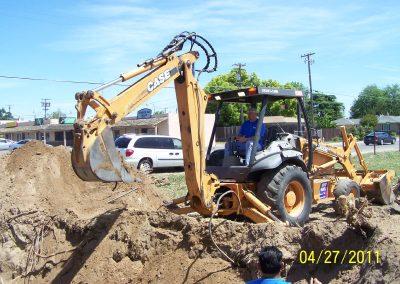Commercial plumbing pipe installation by Valley City Plumbing with backhoe